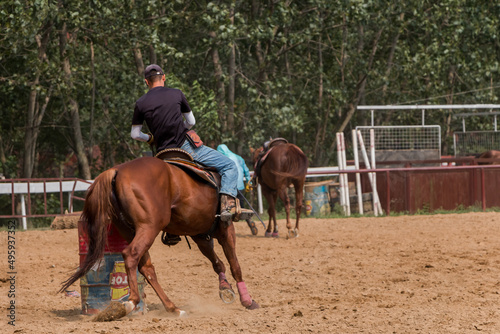 horse farm, a young rider on horseback trains an animal to go around an obstacle © Alesia