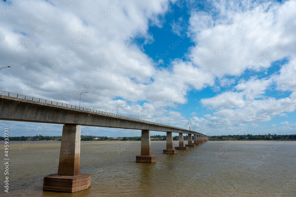 Landscape of Mukdahan Thai-Laos Friendship Bridge II viewpoint at Mekong river in cloudy blue sky background at Mukdahan province, Thailand.