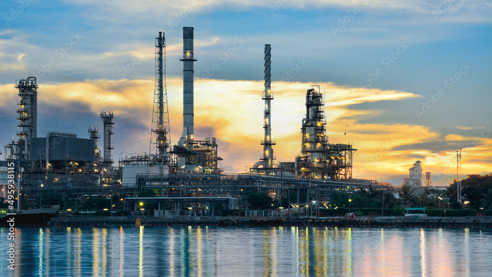 Oil and gas refinery plant area at sunrise near sea port or river
