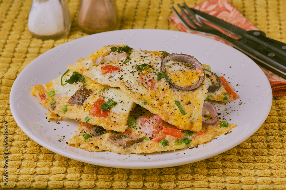 Spanish frittata shot on a yellow background. Spanish frittata shot on a yellow background.