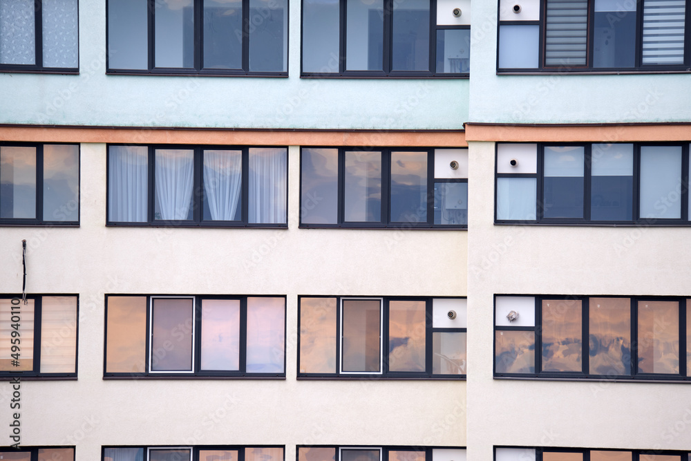 Architectural details of modern high apartment building facade with many windows and balconies Architectural details of modern high apartment building facade with many windows and balconies