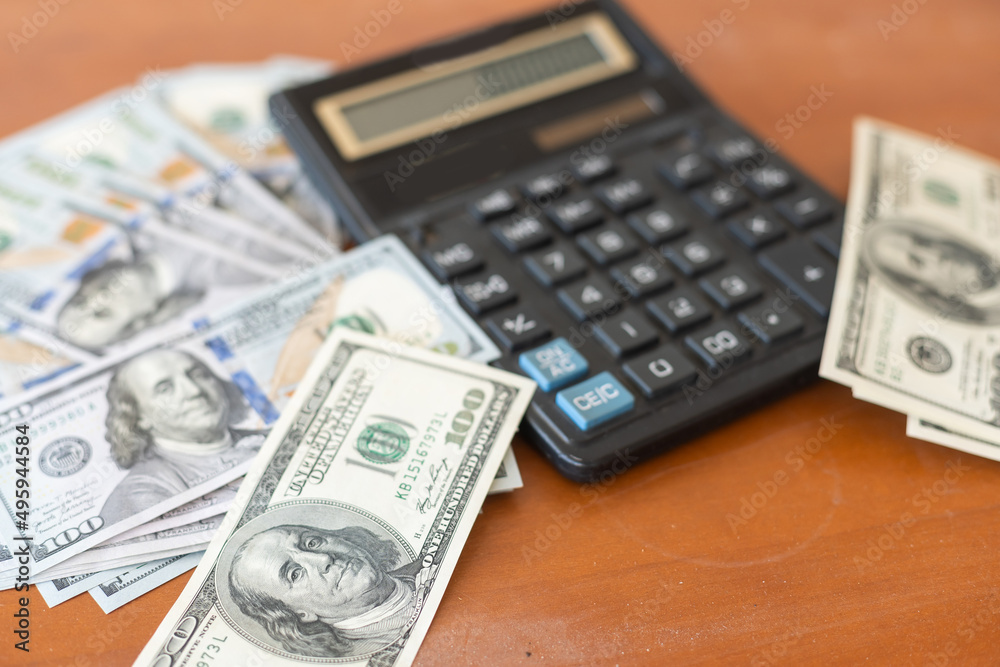Money and calculator on wooden table. Money and calculator on wooden table.