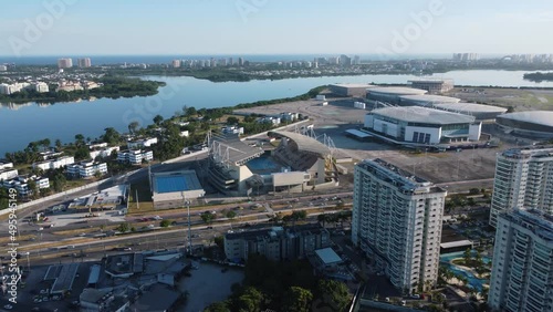 Aerial view of Jacarépaguá Lagoon in Rio de Janeiro, Brazil. Residential buildings and mountains around. Cars on Aberlado Bueno Avenue. Barra da Tijuca in the background. Sunny day. Drone take. photo