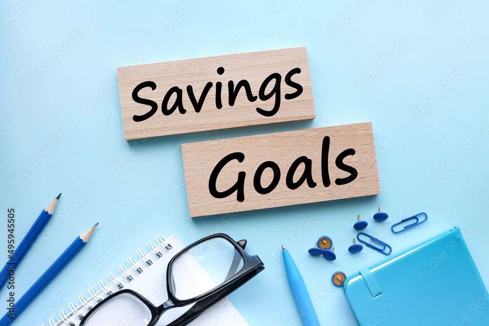 SAVING GOALS. Financial and business concept. text on wooden blocks on blue background