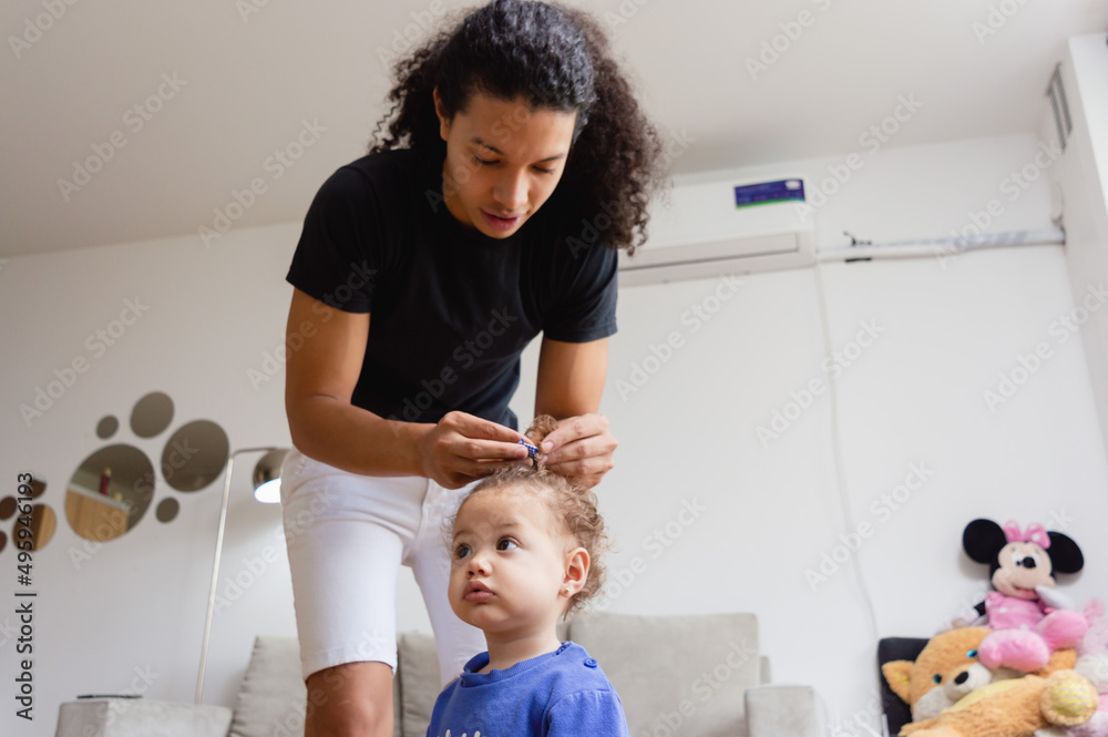 caucasian young father at home combing his little daughter caucasian young father at home combing his little daughter