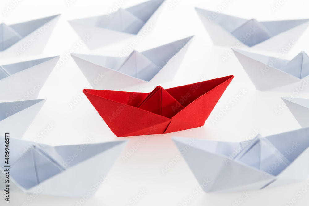 Red paper boat stands out Red paper boat stands out
