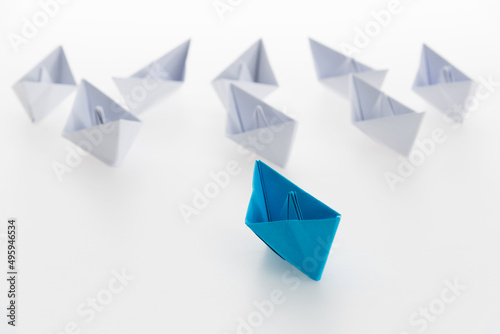 The blue origami boat is leader