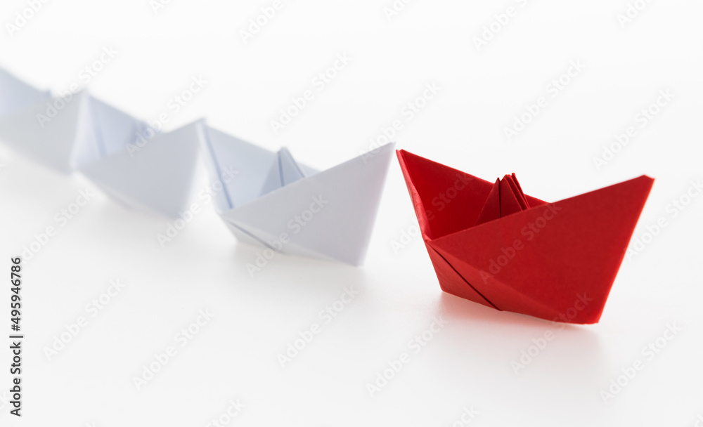 The red origami boat is leader The red origami boat is leader