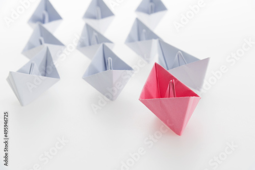 The pink origami boat is leader