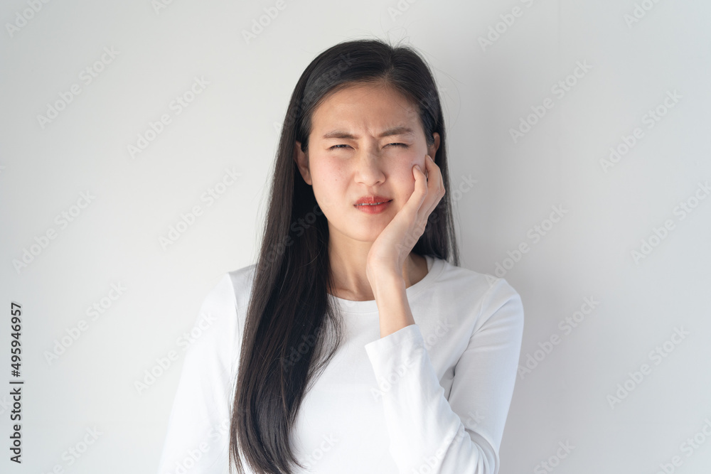 Teeth and gum problem concept. Asian young woman touching cheek and feeling toothache and pain face expression. Teeth and gum problem concept. Asian young woman touching cheek and feeling toothache and pain face expression.