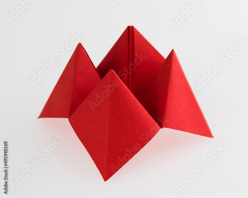 Origami paper fortune on white background photo