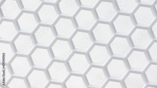 Detalle de cuadrícula de celdas hexagonales en rejilla de plástico blanco photo