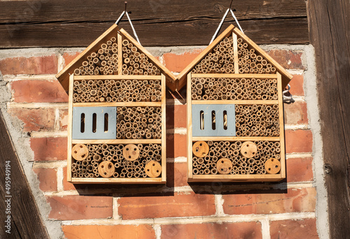 small insect hotels at a brick facade
