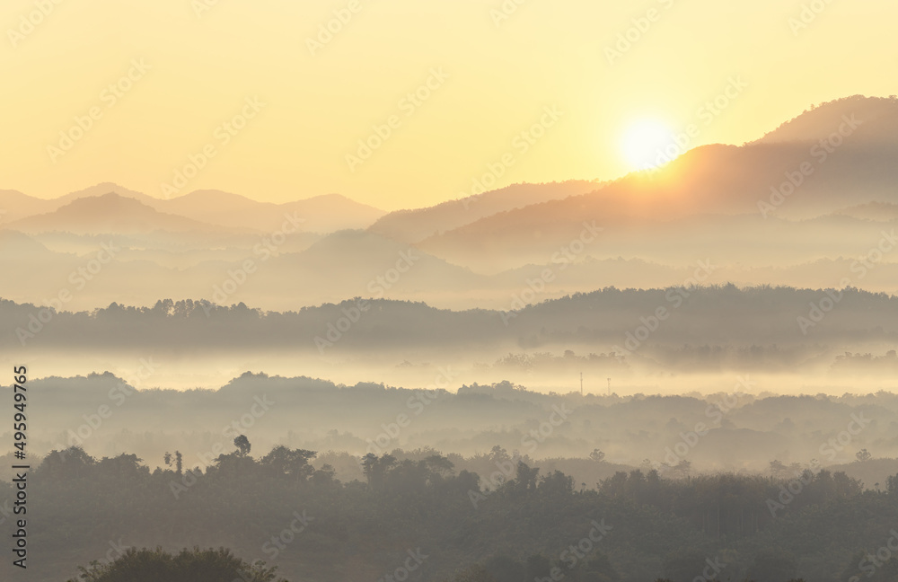 Beautiful scenary of foggy with mountain range landscape. Mist on valley in first rays sun, Amazing nature scenery, Tourism and travel concept .