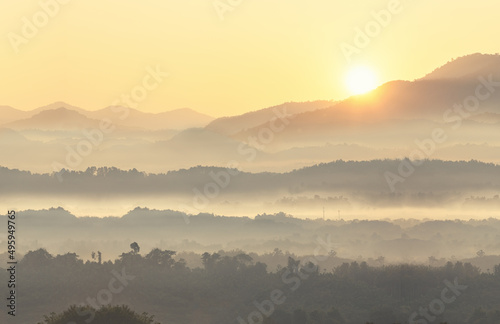 Beautiful scenary of foggy with mountain range landscape. Mist on valley in first rays sun, Amazing nature scenery, Tourism and travel concept .