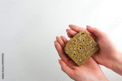 Female hands holding slice of homemade sunflower bread
