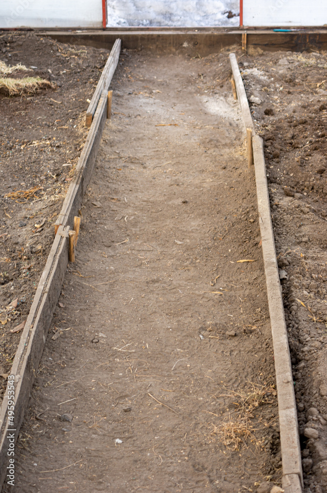 Earthen garden path in a warm greenhouse Earthen garden path in a warm greenhouse