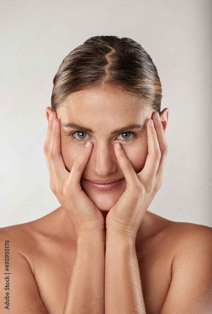 My skin has never felt better. Closeup studio portrait of a beautiful young woman touching her face. My skin has never felt better. Closeup studio portrait of a beautiful young woman touching her face.