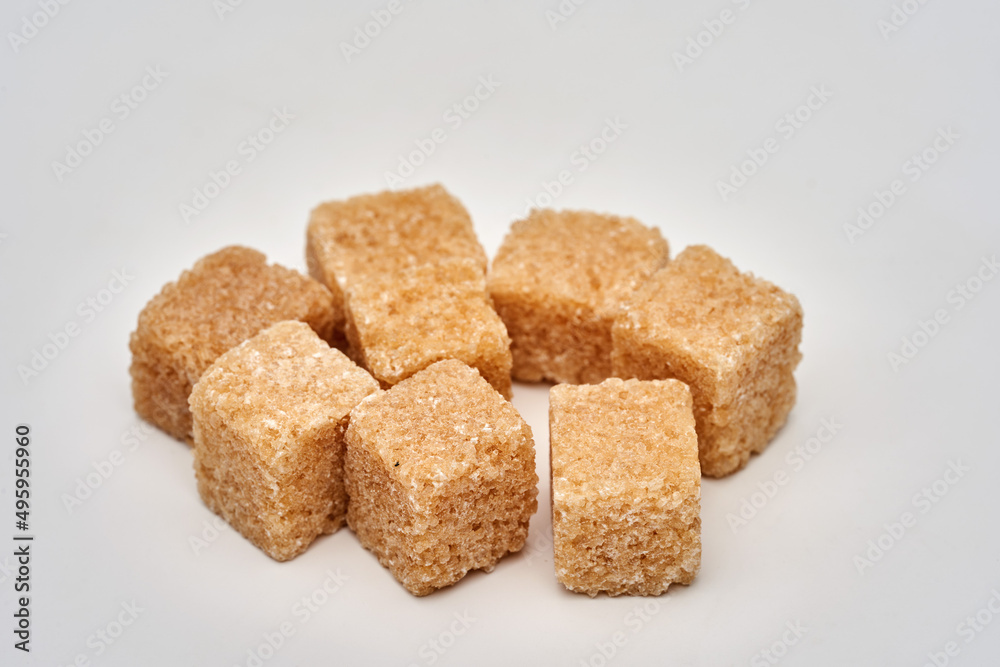 Closeup of brown sugar cubes on white Closeup of brown sugar cubes on white