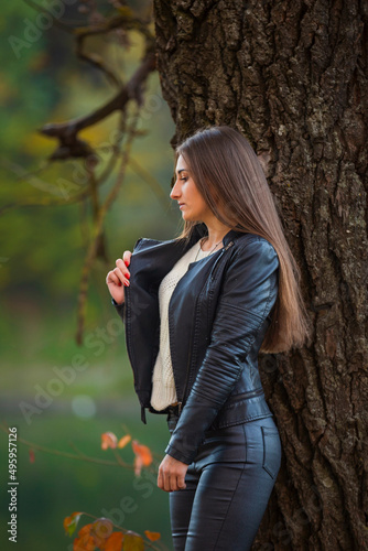 girl in black leather clothes near the tree © zokov_111