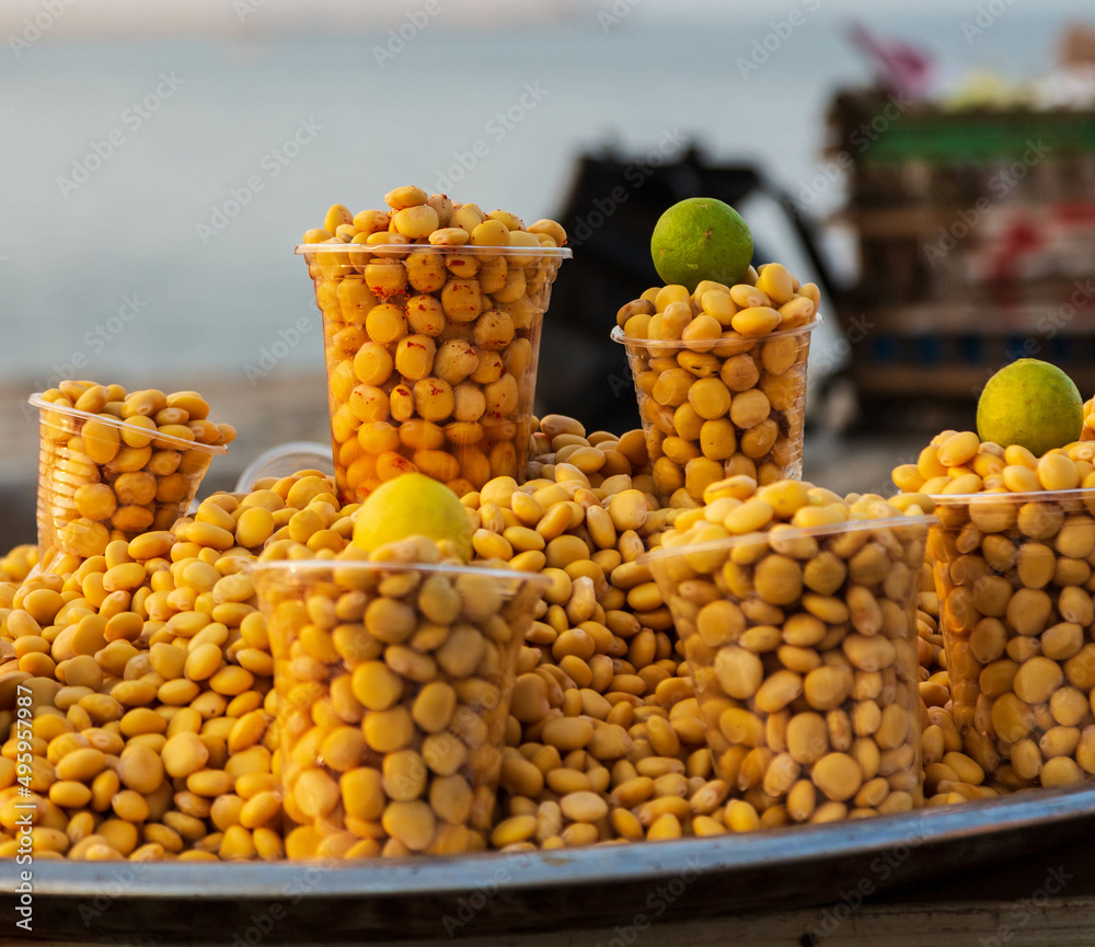 Arabic Cuisine; Middle Eastern traditional snack Lupin beans or Termes selling in plastic glasses with limes in the street. Alexandria, Egypt