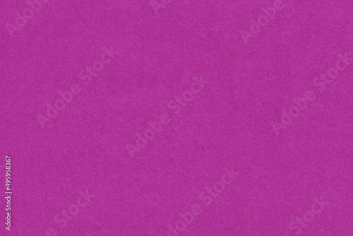 Paper background in monochromatic lilac color with a fibrous texture. Paper background in lilac color with empty space for text or advertisement. Uniform paper texture for packaging or background
