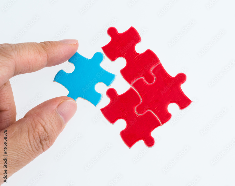 Hand put the blue piece in red puzzles Hand put the blue piece in red puzzles