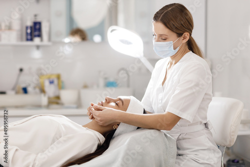 Doctor doing face massage and mask for skin