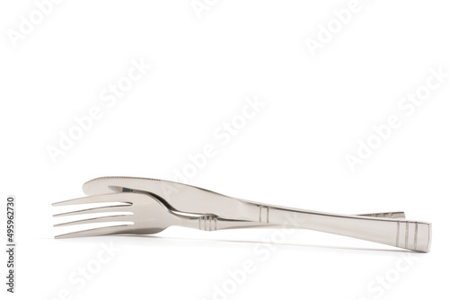 Knife and fork stacked up isolated on white background. Side View.