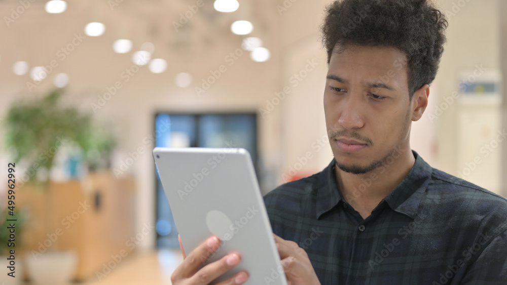 African American Man using Digital Tablet African American Man using Digital Tablet