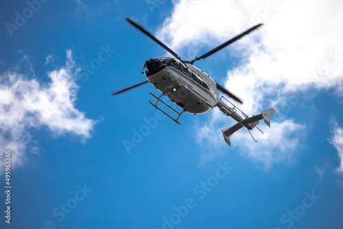 Fototapeta Naklejka Na Ścianę i Meble -  Helicopter close-up against the sky. Rescue helicopter flies in the sky with clouds.