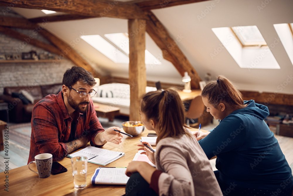 Young student talks to his female friends while learning together at home. Young student talks to his female friends while learning together at home.