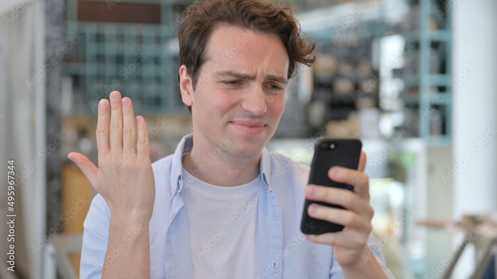 Man Reacting to Loss on Smartphone Man Reacting to Loss on Smartphone