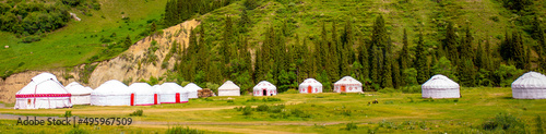 Yurt. National ancient house of the peoples of Kazakhstan and Asian countries. National Housing. Yurts on the background of a green meadow and highlands. © Vera