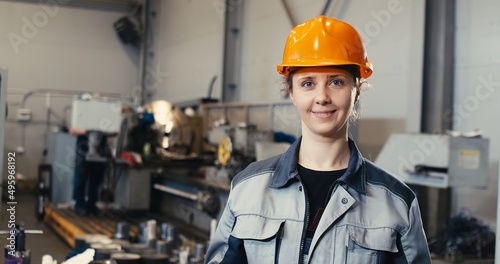 Obraz na plátně Portrait of a professional heavy industry engineer in uniform, goggles and a hard hat in a steel mill
