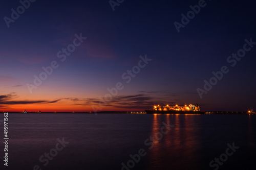 LNG TANKER - Ship at the gas terminal with sunrise 