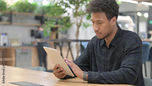 Attractive African American Man using Tablet at Work 
