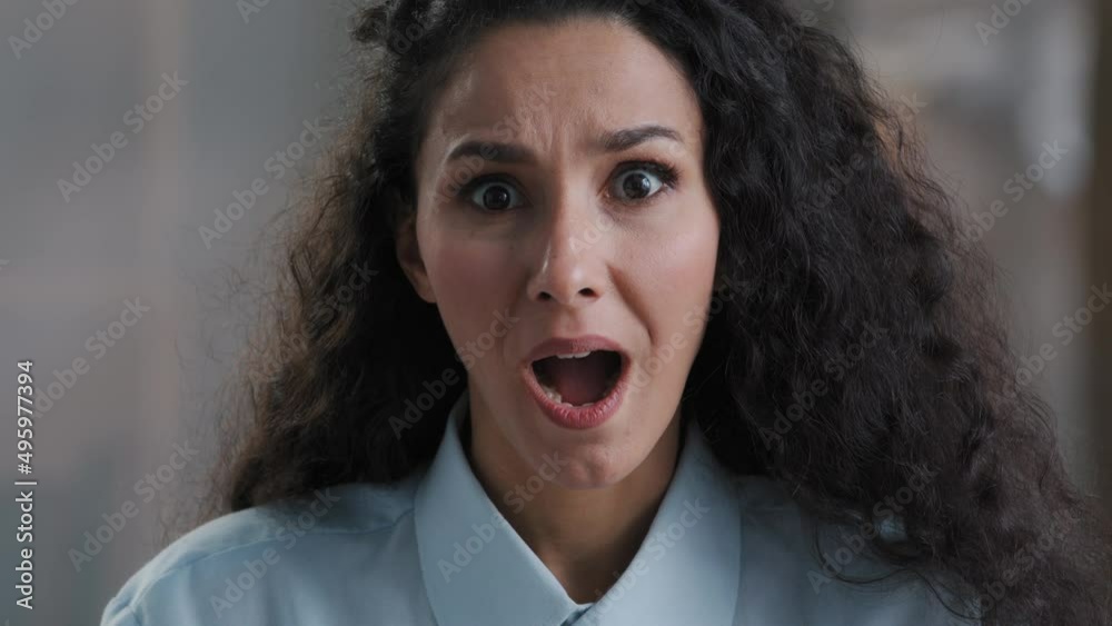Amazed beautiful young arab business lady girl office worker surprised looking at camera making big eyes shocked by sudden victory close up shocked woman winner demonstrate wow emotion face expression