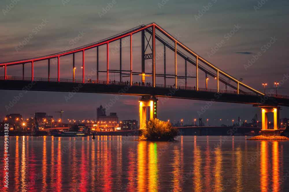 Fototapeta premium Pedestrian Bridge with lights at evening in Kiev, Ukraine