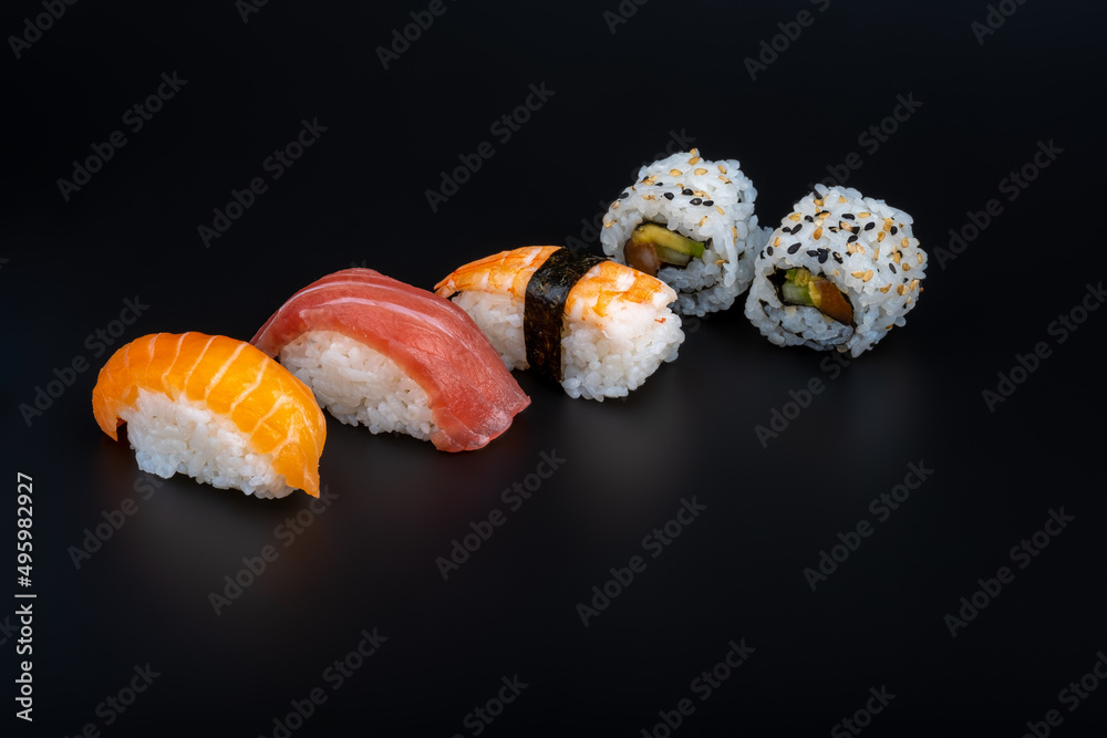 varied sushi ration with black background and props varied sushi ration with black background and props