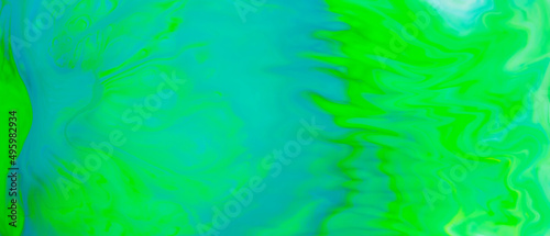 Fluid art background in green color. Green-turquoise stains on liquid. Creative background with blurred paints