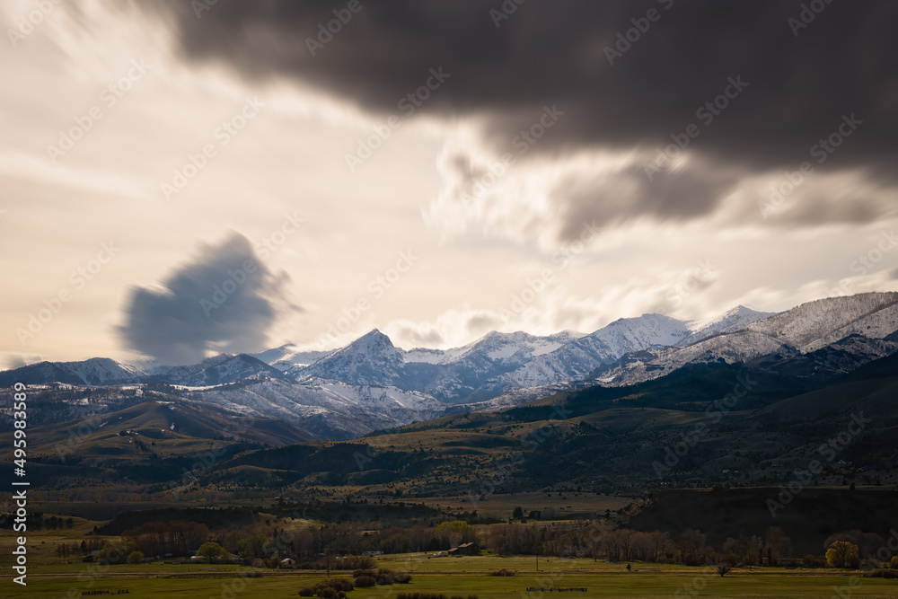 2022-03-29 SNOW COVERED ABSAROKA MOUNTATIN RANGE AND VALLEY NEAR PRAY MONTANS WITH BLURRY FAST MOVING STORM CLOUDS