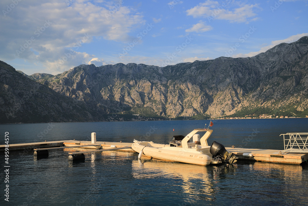 Fototapeta premium Motor boat near the pier at sunset