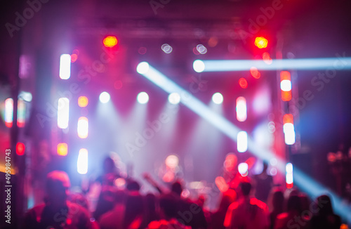 Color disco club light with laser show and dancing people