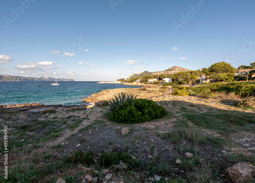 Mountains, green flora and mediterranean sea turquoise water of Alcudia, Mallorca, or Majorca, Balearic Islands, Spain