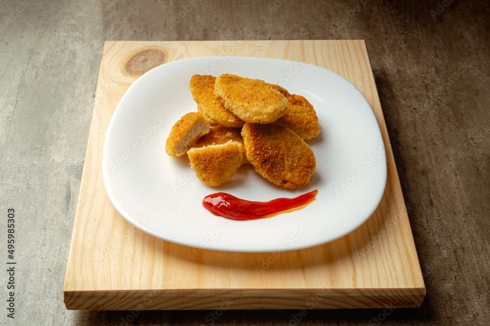 Chicken nuggets with crispy fried bread, wooden bottom. Tasty chicken nuggets. Chicken nuggets with crispy fried bread, wooden bottom. Tasty chicken nuggets.