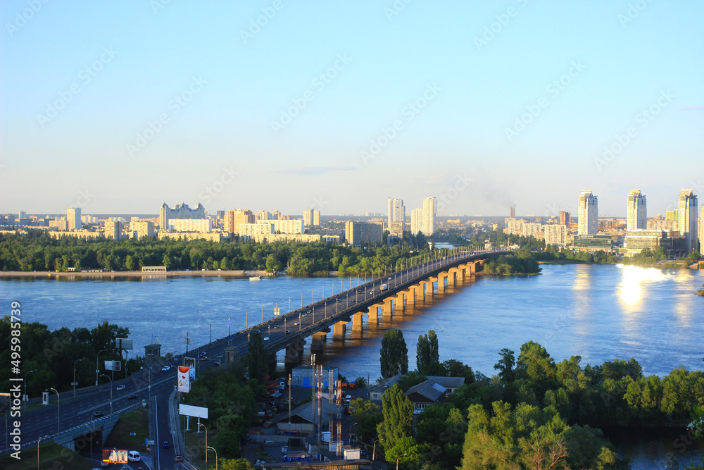 Panorama of evening Kyiv. View of the Paton bridge across the Dnieper and the left bank of Kyiv.