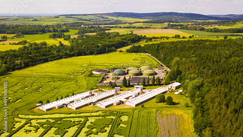 Aerial view of biogas plant near farm in countryside. Ecological renewable energy production from agricultural waste. New green modern agriculture in Dobrany, Czech Republic, European Union. 