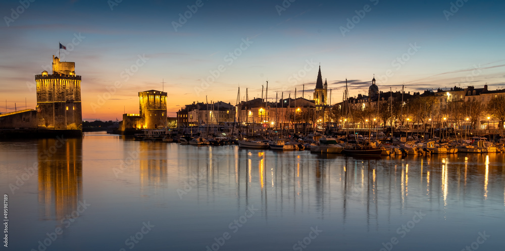 Panoramic view of the old harbor of La Rochelle at sunset. beautiful city lights