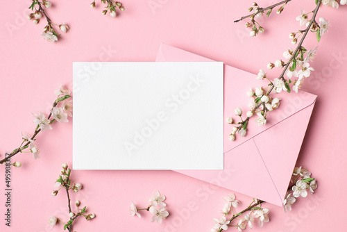 Blank greeting card mockup with envelope and white flowers